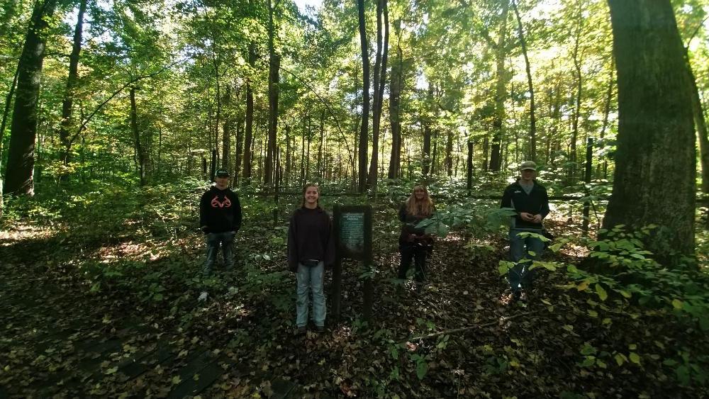 A photo of geoscience students taken out in a forest