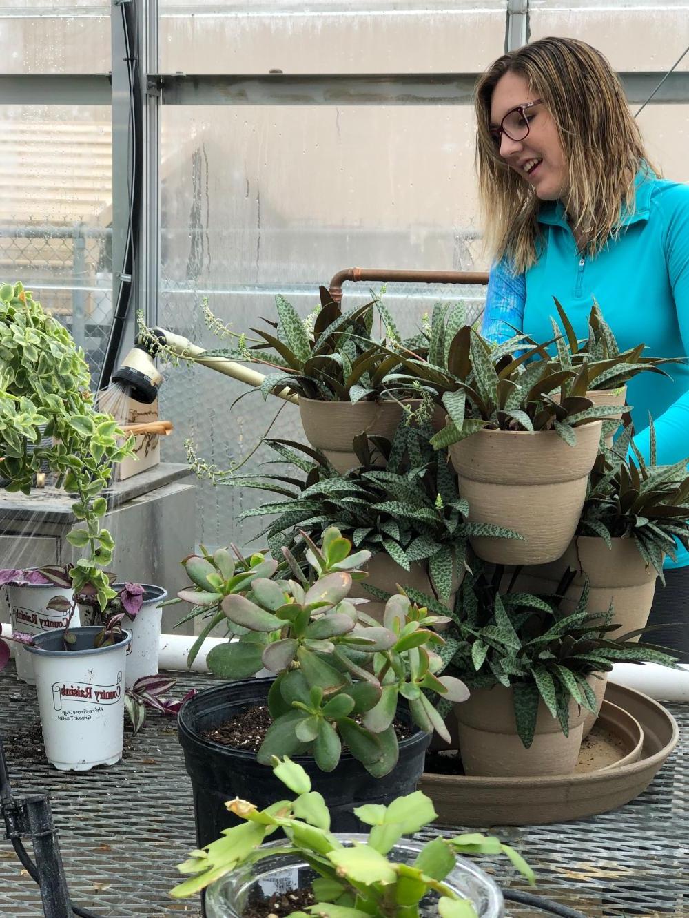 A geoscience student with a variety of plants